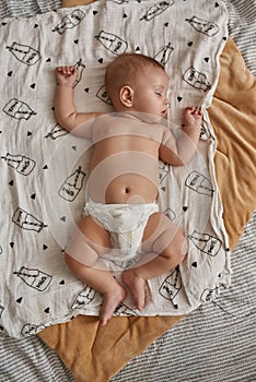 Little baby in diaper on white blanket, flat lay