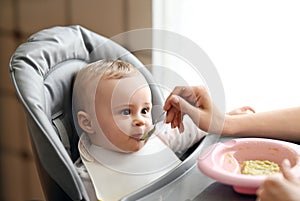 Little baby eating vegetable puree