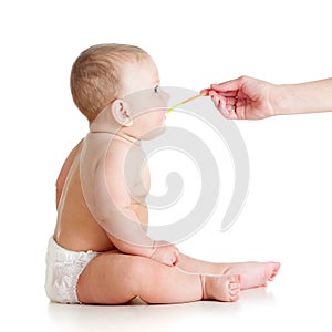 Little baby feeding with a spoon