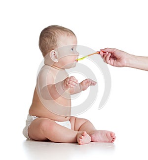Little baby feeding with a spoon