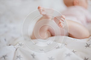 Little baby feet on a swaddle blanket