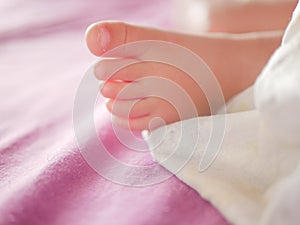 Little baby feet. Theres nothing quite so sweet as tiny little baby feet. Little baby boy on bed. Close up. Space for copy