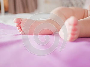 Little baby feet. Theres nothing quite so sweet as tiny little baby feet. Little baby boy on bed. Close up. Space for copy