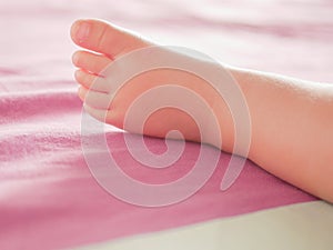 Little baby feet. Theres nothing quite so sweet as tiny little baby feet. Little baby boy on bed. Close up. Space for copy photo