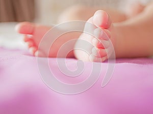 Little baby feet. Theres nothing quite so sweet as tiny little baby feet. Little baby boy on bed. Close up. Space for copy photo