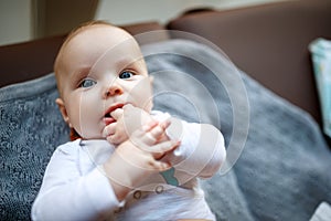 Little baby with fingers in mouth