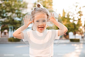 Little baby girl 4-5 year old having fun outdoor over city background close up