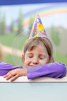 Little baby girl Celebrating her birthday. Hat and festive mood