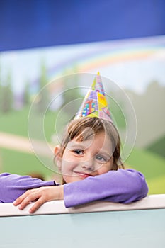 Little baby girl Celebrating her birthday. Hat and festive mood