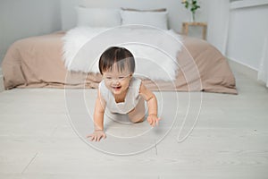 Little baby girl or girl crawling on floor in bed room