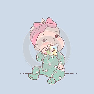 Little baby girl in green pajamas sit, hold teething ring