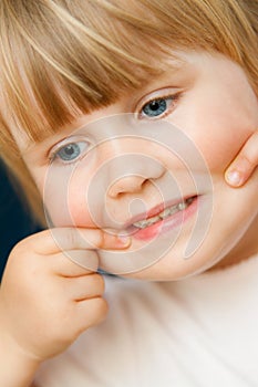 Little baby girl making face portrait