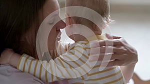 Little baby girl and mommy playing wooden eco toys at home. Mother and daughter laughing having fun together