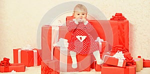 Little baby girl play near pile of gift boxes. Celebrate first christmas. Baby first christmas once in lifetime event