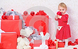 Little baby girl play near pile of gift boxes. Family holiday. Christmas activities for toddlers. Christmas gifts for