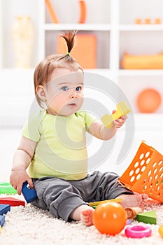 Little baby girl playing with toys