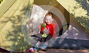 Little Baby Girl sitting in Camping Tent in Forest