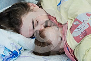 Little baby girl sleeping with dad in the morning. Happy parent. Father lying on bed. Happy family.