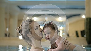 Little baby girl swimming. Learning infant child to swim