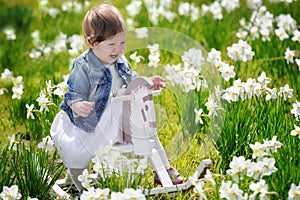 Little baby girl on wooden rocking horse