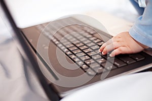 Little baby hand on laptop