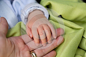 Little baby hand in mothers hand