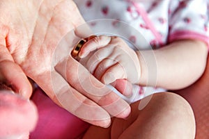 Little baby holding mother`s hand