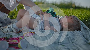 Little baby infant girl crying at an outdoor picnic.