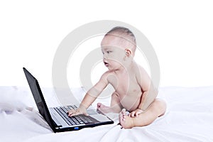 Little baby and laptop computer