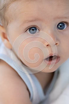 Little baby with large trusting blue eyes