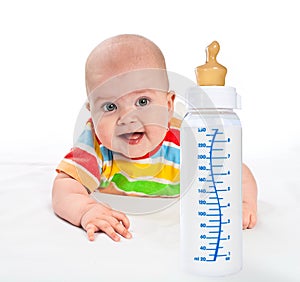 Little baby with milk bottle.