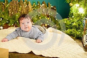 Little baby and new year. Children`s first Christmas. Beautiful little child celebrates Christmas. New Year holidays. A child wit