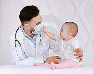 Little Baby Patient Touching Doctor`s Face Mask During Appointment Indoor