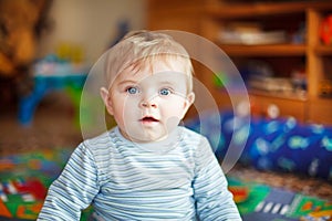 Little baby playing with different toys indoors