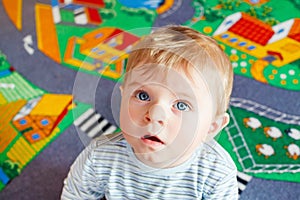 Little baby playing with different toys indoors