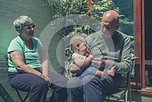 Grandparents in yard with baby