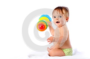 Little baby playing with pyramid toy