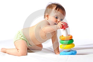 Little baby playing with pyramid toy