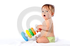 Little baby playing with pyramid toy