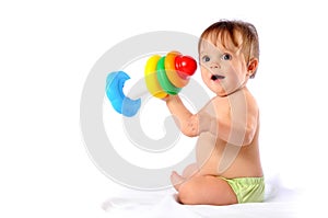 Little baby playing with pyramid toy