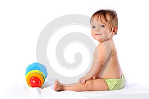 Little baby playing with pyramid toy