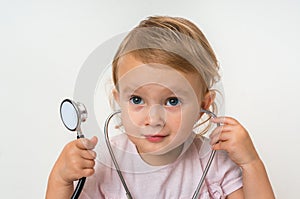 Little baby plays doctor with stethoscope