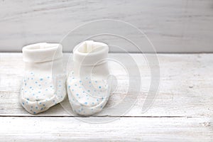 Little baby`s bootees on white background