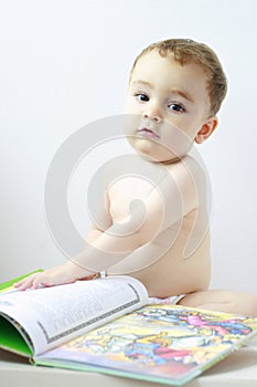 Little baby scanning a big book