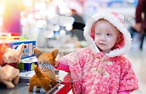 Little baby shopping for gifts in the mall, shopping center .