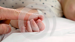 Little baby sleeping father gives by the hand. selective focus.