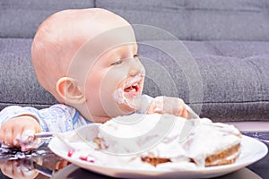 Little baby smash birthday cake with a spoon, happy birthday.