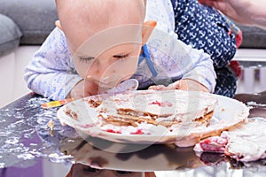 Little baby smash birthday cake with a spoon, happy birthday.