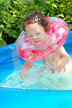 Little baby splashing in waterpool