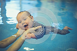 Little baby swimming in the pool